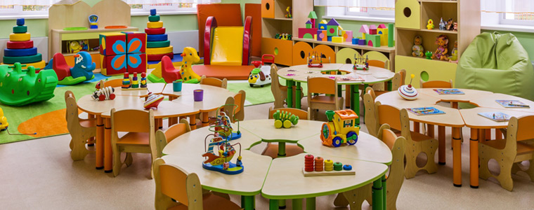 Sala de juegos con mesas de colores en una guardería infantil